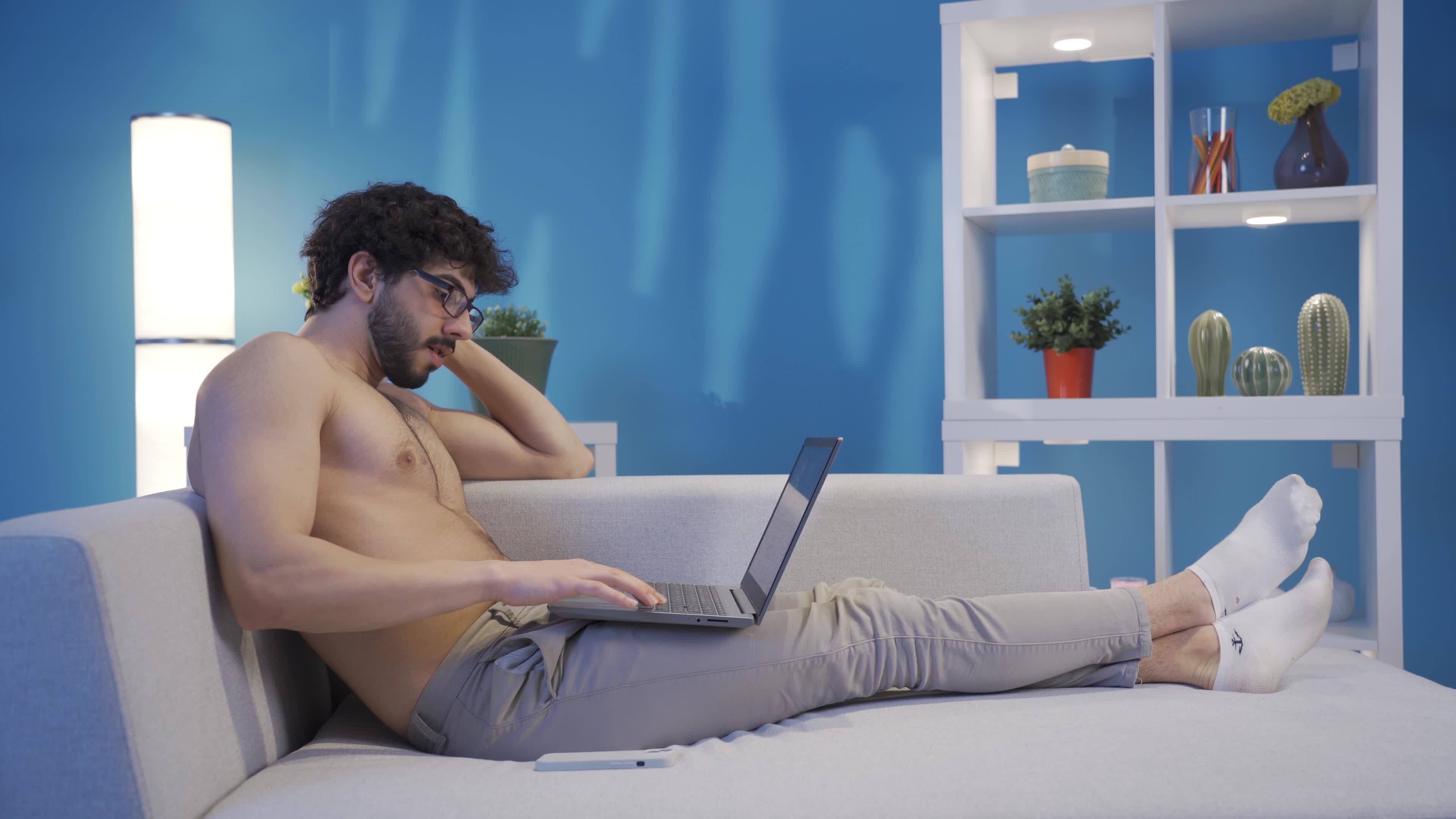 computer naked Smiling young naked man enjoying friendly communication using laptop. Young  man using laptop computer typing something on keyboard, preparing text,  texting, sending mail. 21807681 Stock Video at Vecteezy