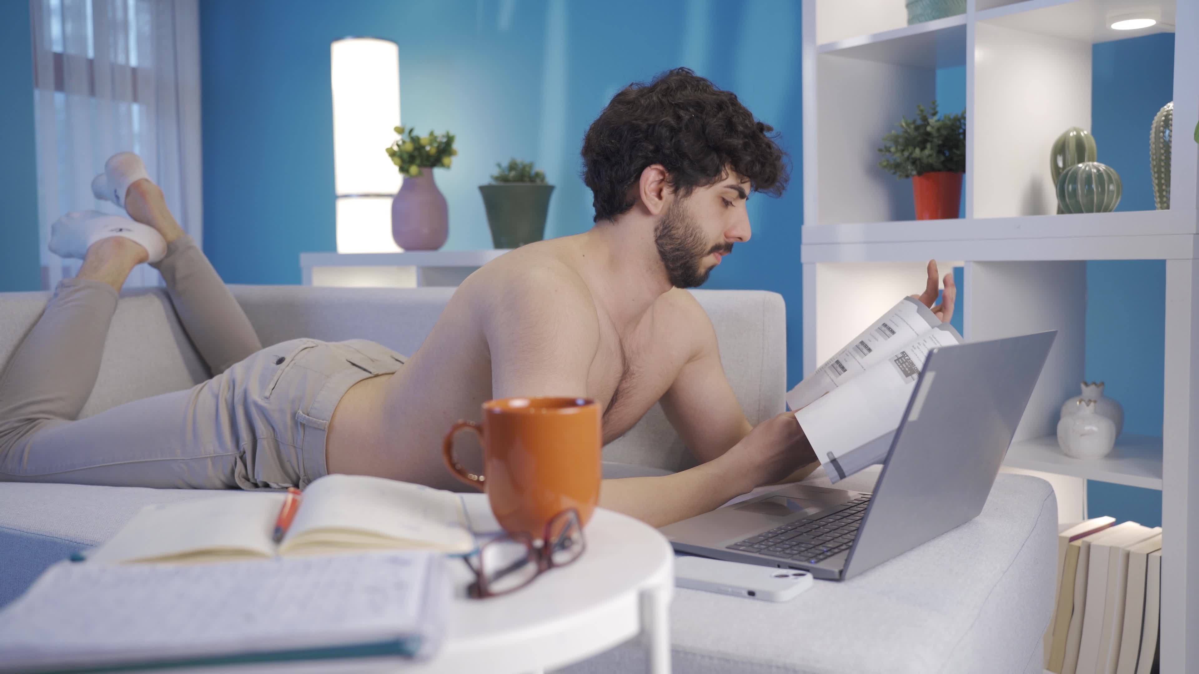 computer naked Attractive naked young man working in home office using laptop, taking  notes. Handsome and attractive young man using laptop alone at night at  home working in home office concept. 21807890 Stock Video