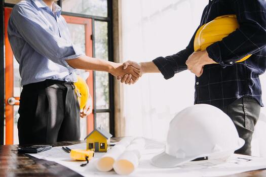 Construction and structure concept of Engineer or architect meeting for project working with partner and engineering tools on model building and blueprint in working site, contract for both companies. photo