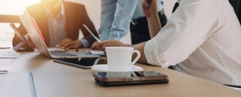 Entrepreneurs and business people conference in modern meeting room, happy multiracial coworkers have fun cooperating working together at office meeting, asian teamwork concept photo