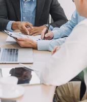 Entrepreneurs and business people conference in modern meeting room, happy multiracial coworkers have fun cooperating working together at office meeting, asian teamwork concept photo