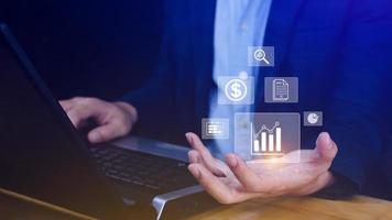 Big data analytics and business intelligence BI concept with chart and graph icons on digital screen interface and business people in the background. photo