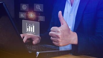 Big data analytics and business intelligence BI concept with chart and graph icons on digital screen interface and business people in the background. photo