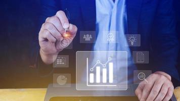 Big data analytics and business intelligence BI concept with chart and graph icons on digital screen interface and business people in the background. photo