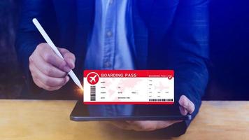 Hand holding boarding pass tickets air travel concept, Choosing checking electronic flight ticket on laptop.