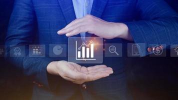 Big data analytics and business intelligence BI concept with chart and graph icons on digital screen interface and business people in the background. photo