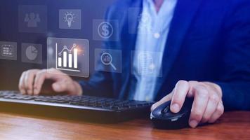 Big data analytics and business intelligence BI concept with chart and graph icons on digital screen interface and business people in the background. photo