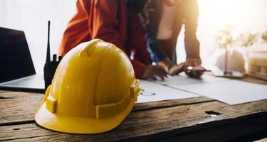 Construction and structure concept of engineer working drawing on blueprint meeting for project working with partner on model building and engineering tools in working site, construction concept photo