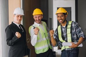 Diverse Team of Specialists Use Tablet Computer on Construction Site. Real Estate Building Project with Civil Engineer, Architect, Business Investor and General Worker Discussing Plan Details. photo