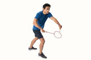 A badminton player in sportswear stands holding a racket and shuttlecock. photo