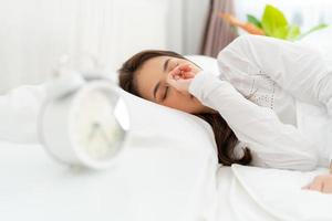 Alarm clock with good day against background happy young woman. photo