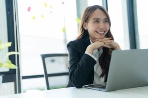 Businesswoman working on a laptop for business information. photo