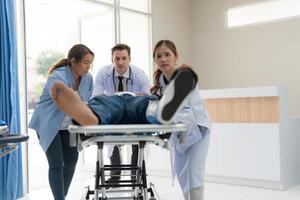 The doctor puts a splint on a patient with a leg. photo