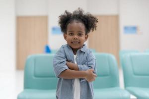 A girl sitting and standing waiting for a check-up. photo