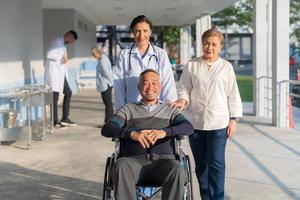 Doctor pushing a wheelchair. photo