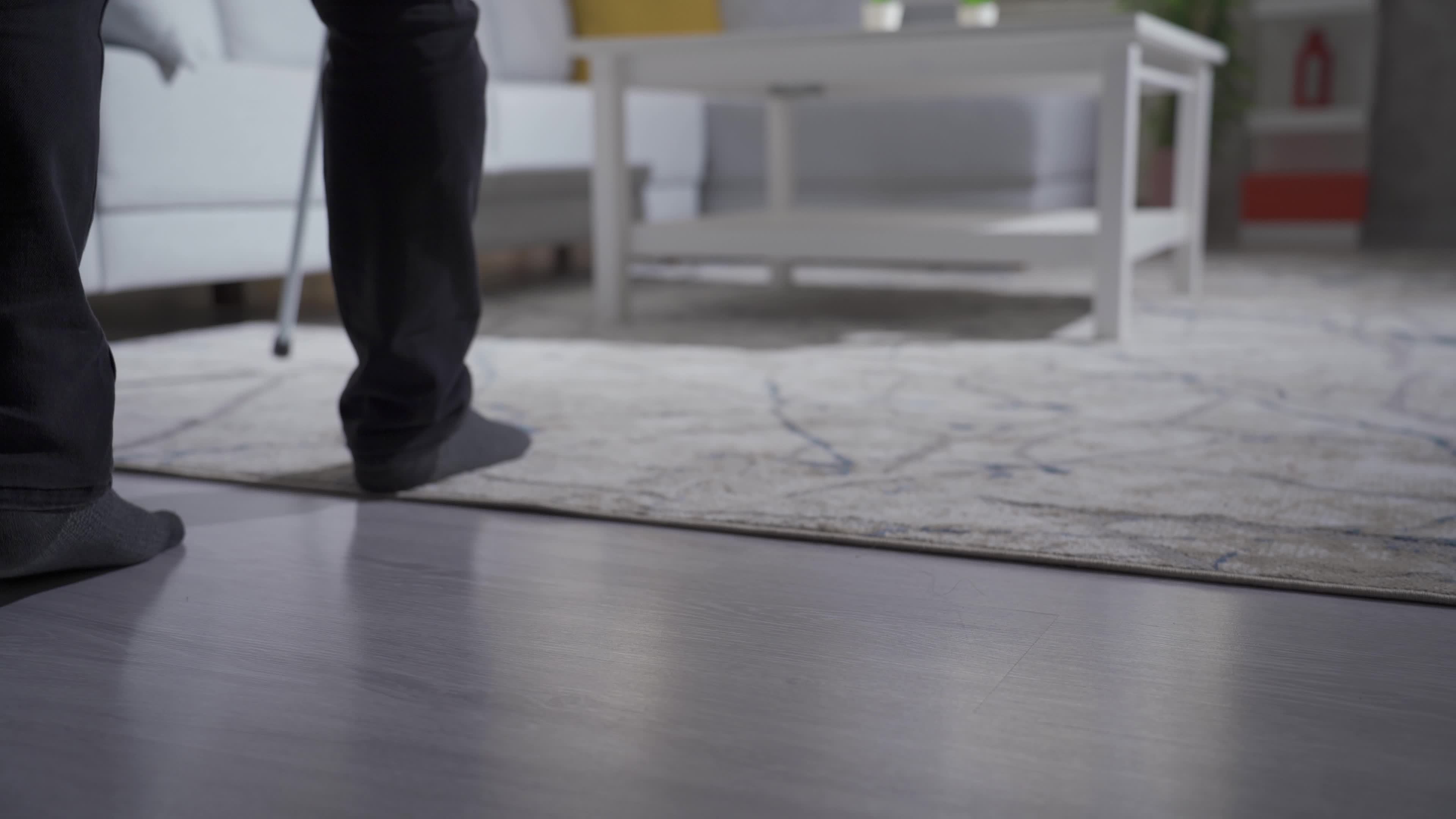 lind man walking around the house with the help of a cane. Closeup