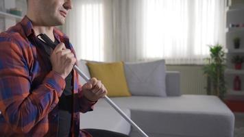 Thoughtful facial expression of blind man holding his walking stick. The blind man sitting in his house is thoughtful. He is holding on to his cane. video