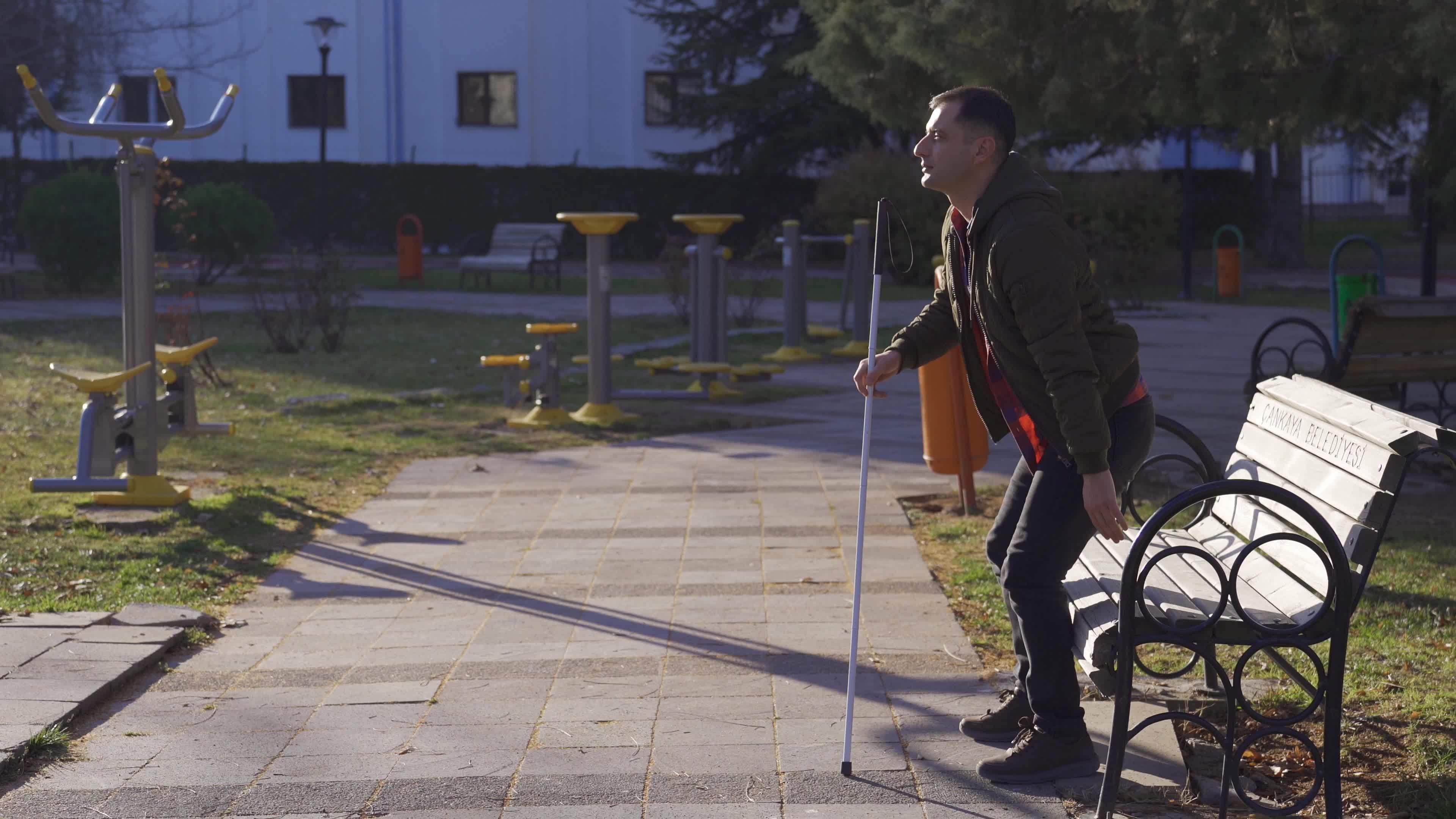 the-blind-man-sitting-on-a-bench-gets-up-and-starts-walking-with-the