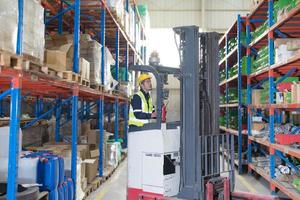 Male employee using a radio in the warehouse. photo