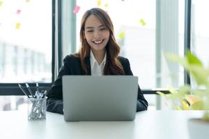 Businesswoman working on a laptop for business information. photo