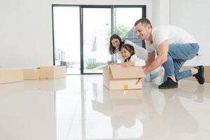 Happy family with girl moving into a new home. photo