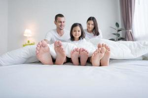 Close up of six feet in a white bed. photo