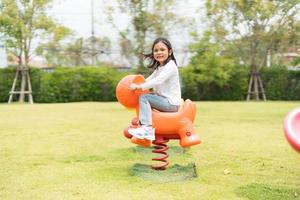 The girl was happily playing in the garden. photo