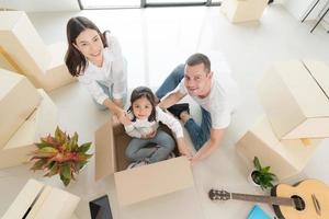 Happy family with girl moving into a new home. photo