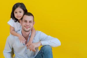 The father sat on the floor as his beloved daughter. photo