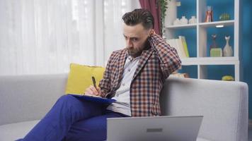 Tired businessman working at home using laptop and getting overwhelmed. Man working with laptop at home getting bored and depressed from work. video