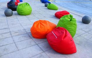 Outdoor colorful Beanbags and grey concrete ball photo