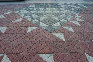 Tuff tiles on foothpath  are made from durable materials,such as stone or concrete,they come in various shape photo