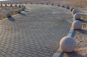 Concrete balls as a parking barriers in the residential area photo