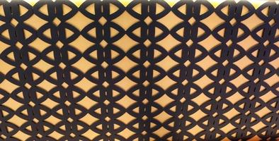 Arabic design based on the repetition and arrangement of simple  gemetric  shapes ,background black and yellow photo