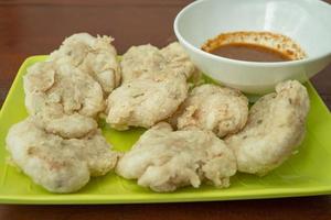 Close up photo of Cireng traditional food of Sundanese West Java. Fried flour with traditional chili sauce. The photo is suitable to use for Indonesia traditional food background, food poster.