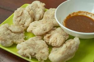 Close up photo of Cireng traditional food of Sundanese West Java. Fried flour with traditional chili sauce. The photo is suitable to use for Indonesia traditional food background, food poster.