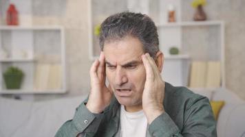 Mature man with medical health problem has a headache. Mature man with health problems has severe headache at home. video