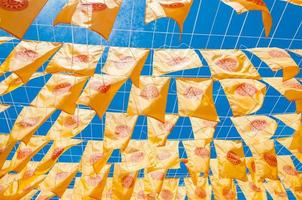 Thammachak flag yellow in temple Wat Phan tao on blue sky temple Northern Thailand photo