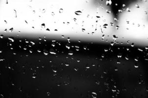 Water drops on glass texture abstract black dark background,Selective focus photo