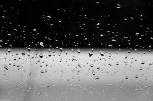 Water drops on glass texture abstract black dark background,Selective focus photo