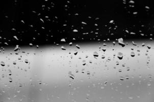 Water drops on glass texture abstract black dark background,Selective focus photo