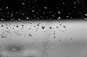 Water drops on glass texture abstract black dark background,Selective focus photo