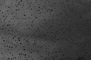 Water drops on black dark surface  texture background photo