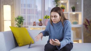 Young woman looking at mobile phone screen, feeling sad and frustrated receiving bad news message or email.