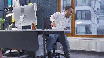 contento enano hombre trabajando en su oficina. él obtiene arriba y mira afuera. el enano hombre es contento en su oficina. él obtiene arriba desde su asiento y mira fuera el ventana, reír. video