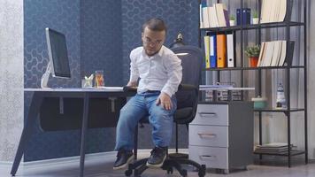 riflessivo Disabilitato nano uomo nel il suo ufficio. Disabilitato nano uomo in piedi nel il suo ufficio e contemplando. annoiato e infelice. video