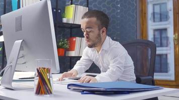 Disabled midget man working on computer in office. Disabled midget man works at the computer in the office. He gets up and looks out the window. video