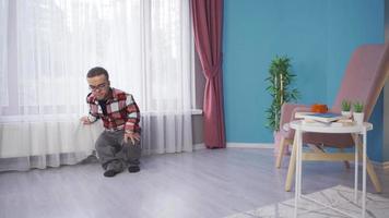 Depressed dwarf man sitting on the floor at home and crying. The dwarf sits on the floor in his house and cries. Unhappy and sad. video