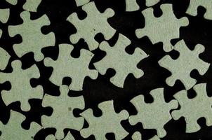 Puzzle pieces on dark background photo