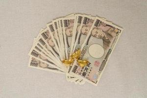 Japanese Yen banknote stack and gold bullion. Thousand Yen money. Japan cash, Recession Economy, Inflation, Investment, finance and saving concepts photo